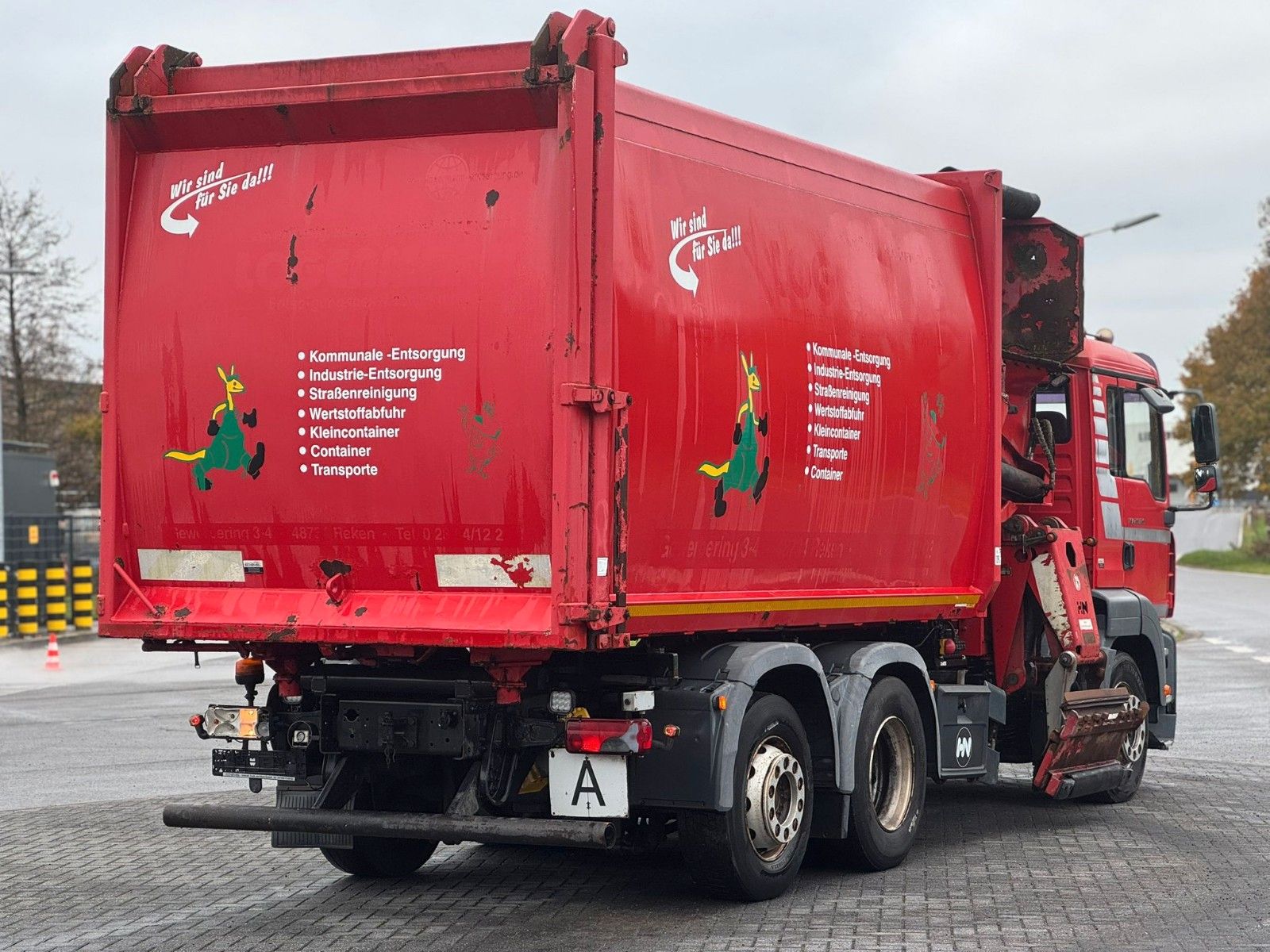 Fahrzeugabbildung MAN TGA 26.320 B/L  6x2 Faun Seitenlader Müllwagen