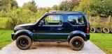 Suzuki Jimmy zweiter Hand in Schwarz mit Hundegit... - gebrauchte Suzuki Jimny aus dem Jahr 2004