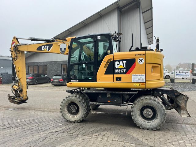 CAT 317 F mit Oilquick 70/55 Trimble