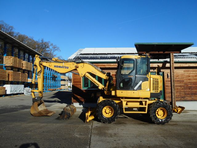 Komatsu PW118MR-VA ( 13,5 Tonnen ) mit Schild u. Pratzen